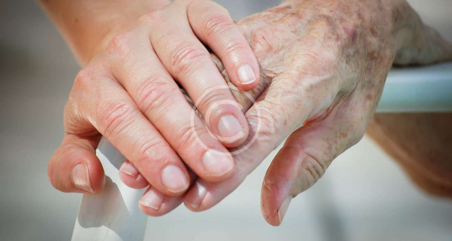Holding hands of elderly person